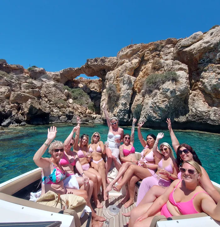 A big group waving in a turquoise cove